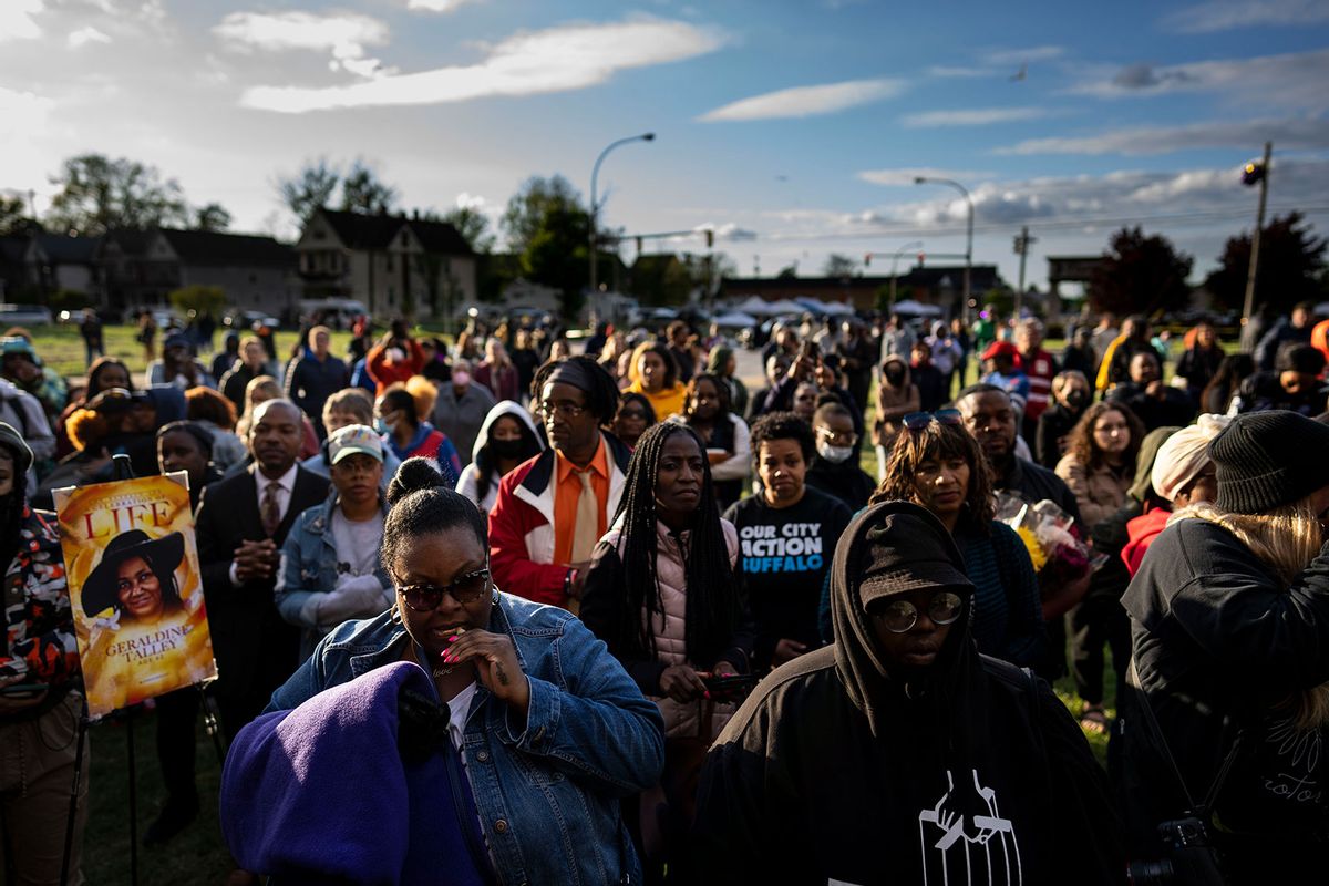 People attend a vigil across the street from Tops Friendly Market at Jefferson Avenue and Riley Street on Tuesday, May 17, 2022 in Buffalo, NY. (Kent Nishimura / Los Angeles Times via Getty Images)