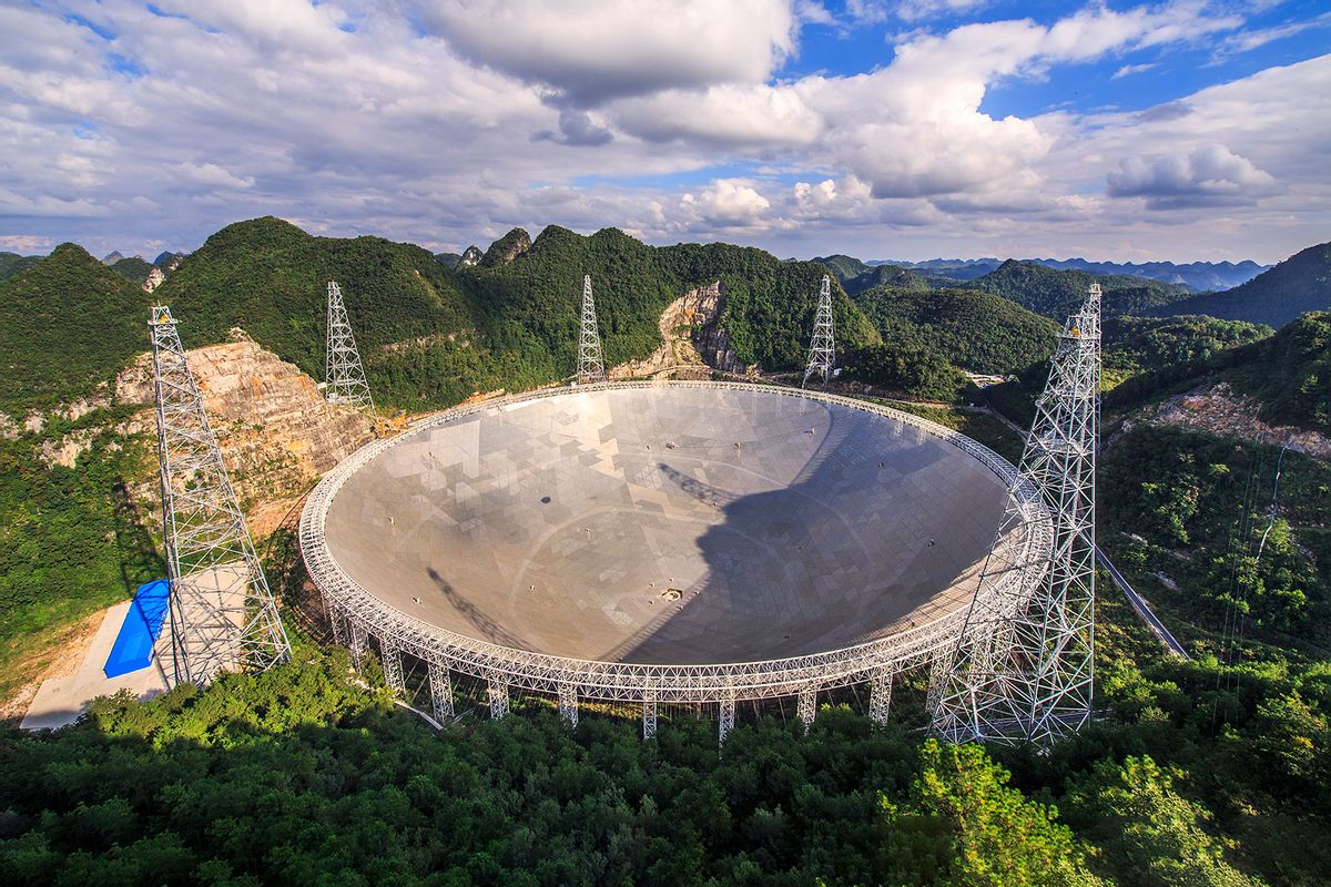 The Five-hundred-meter Aperture Spherical Telescope (FAST) is nestled within a natural basin in China's remote and mountainous southwestern Guizhou province. (Getty Images/Jeff Dai/Stocktrek Images)