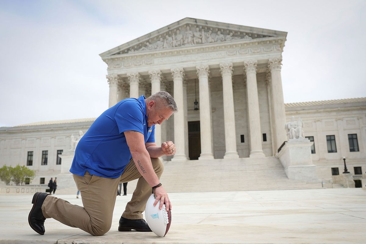 Former Bremerton High School assistant football coach Joe Kennedy takes a knee in front of the U.S. Supreme Court after his legal case, Kennedy vs. Bremerton School District, was argued before the court on April 25, 2022 in Washington, DC. (Win McNamee/Getty Images)