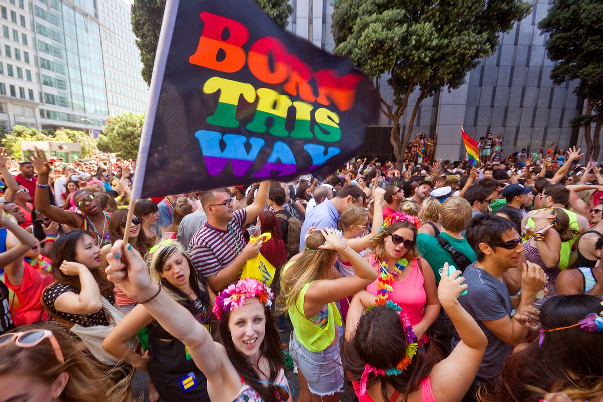 Woman waving a "Born this Way" rainbow flag over the dancing crowd in front of the San Francisco Federal Building, at the Gay Pride Festival. (Getty Images/Tristan Savatier)