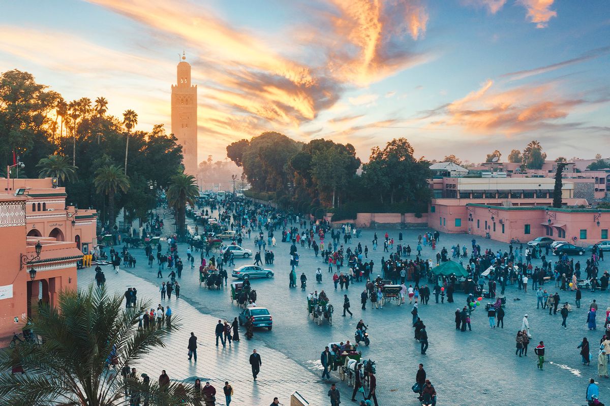The Koutoubia Mosque's minaret and tourists in Djemaa el Fna square at sunset, Marrakech, Morocco (Marco Bottigelli)