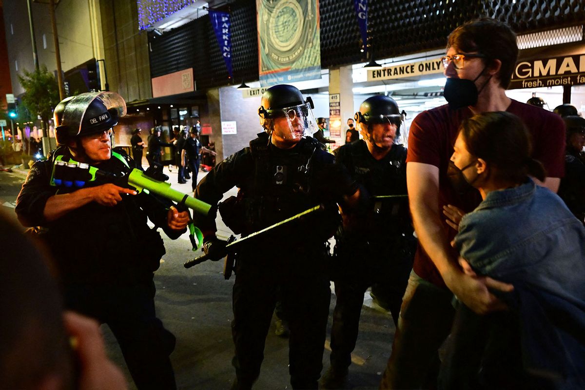 Police holding rubber-bullet guns and batons move to disperse a crowd of abortion rights activists protesting after the overturning of Roe Vs. Wade by the US Supreme Court, in Downtown Los Angeles, on June 24, 2022. (FREDERIC J. BROWN/AFP via Getty Images)