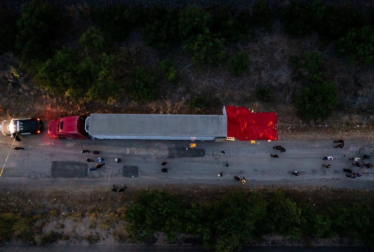 In this aerial view, members of law enforcement investigate a tractor trailer on June 27, 2022 in San Antonio, Texas. According to reports, at least 50 people, who are believed migrant workers from Mexico, were found dead in an abandoned tractor trailer. (Jordan Vonderhaar/Getty Images)