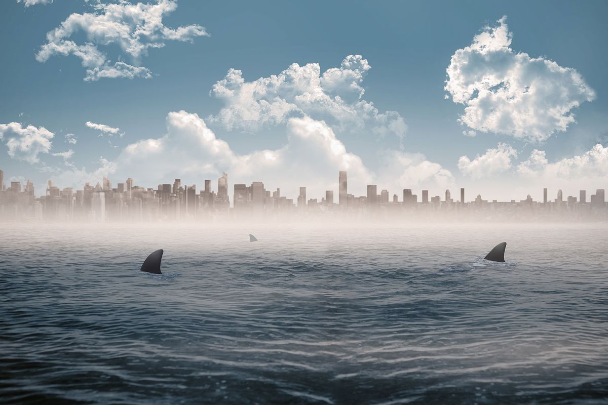 Cityscape on horizon over shark infested sea (Getty Images/Wavebreakmedia)