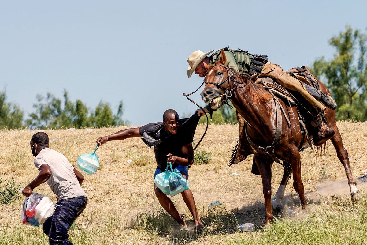 A United States Border Patrol agent on horseback tries to stop a Haitian migrant from entering an encampment on the banks of the Rio Grande near the Acuna Del Rio International Bridge in Del Rio, Texas on September 19, 2021. (PAUL RATJE/AFP via Getty Images)