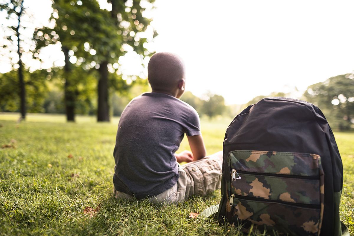Young boy resting in the park (Getty Images/franckreporter)