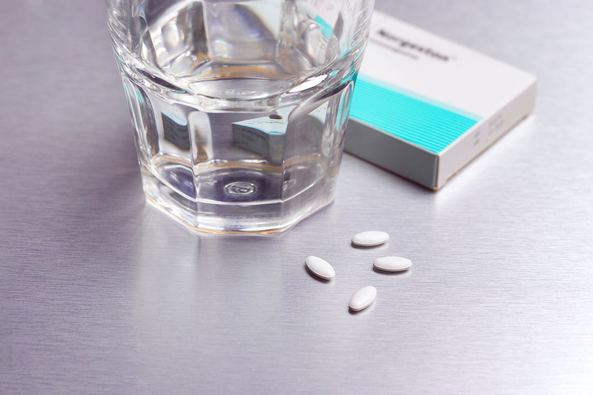 Abortion drug pills and drinking water (Getty Images/Peter Dazeley)