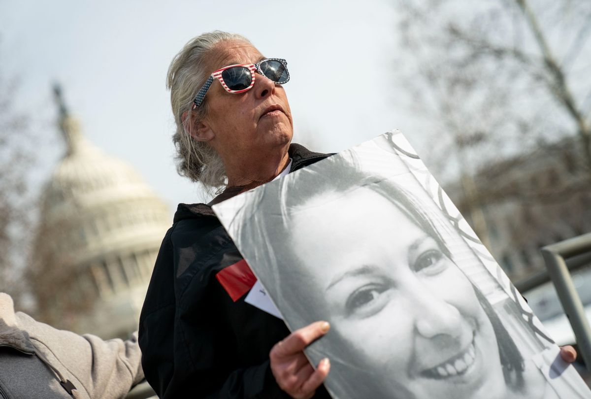 Micki Witthoeft, mother of Ashli Babbitt, holds a photograph of her late daughter who was killed in the January 6 insurrection, while talking on Capitol Hill on Thursday, Jan. 6, 2022 in Washington, DC.  (Kent Nishimura / Los Angeles Times via Getty Images)