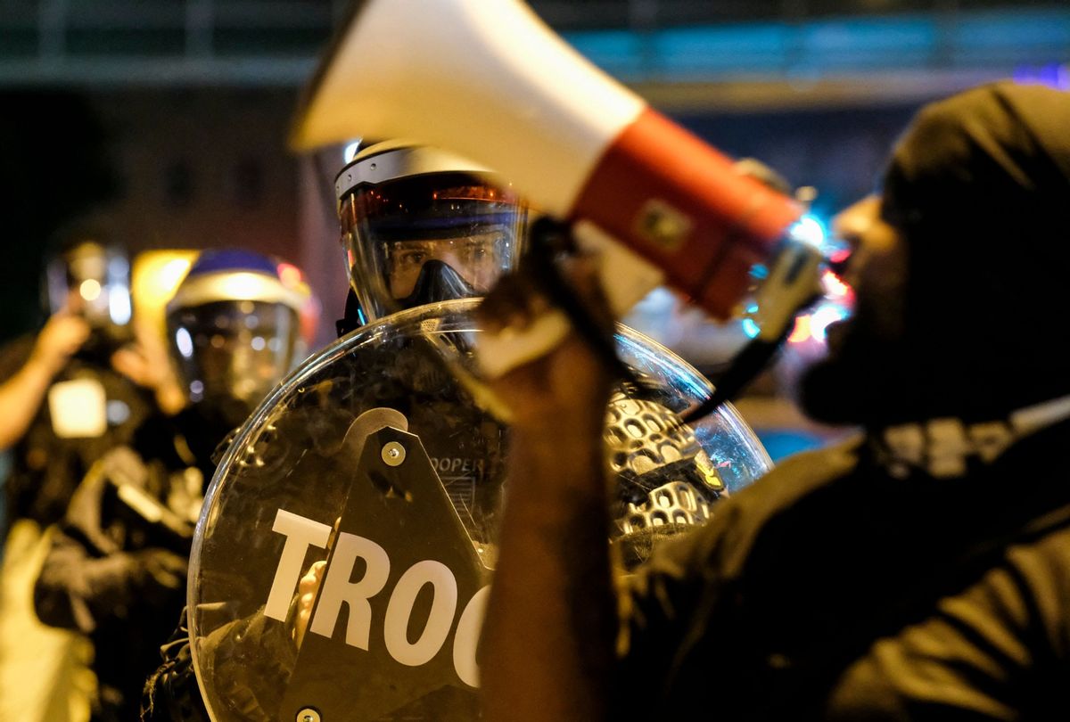 Troopers in riot gear watch as demonstrators gather outside Akron City Hall to protest the killing of Jayland Walker, shot by police, in Akron, Ohio, July 3, 2022.  (MATTHEW HATCHER/AFP via Getty Images)