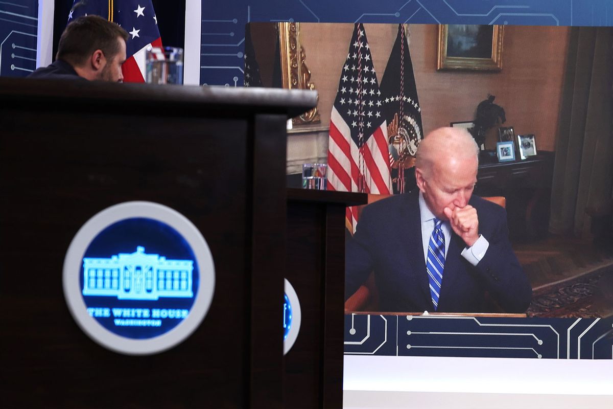 U.S. President Joe Biden covers his mouth as he coughs while remotely attending a meeting on the Creating Helpful Incentives to Produce Semiconductors (CHIPS) for America Act, in the South Court Auditorium at the White House on July 25, 2022 in Washington, DC. (Anna Moneymaker/Getty Images)
