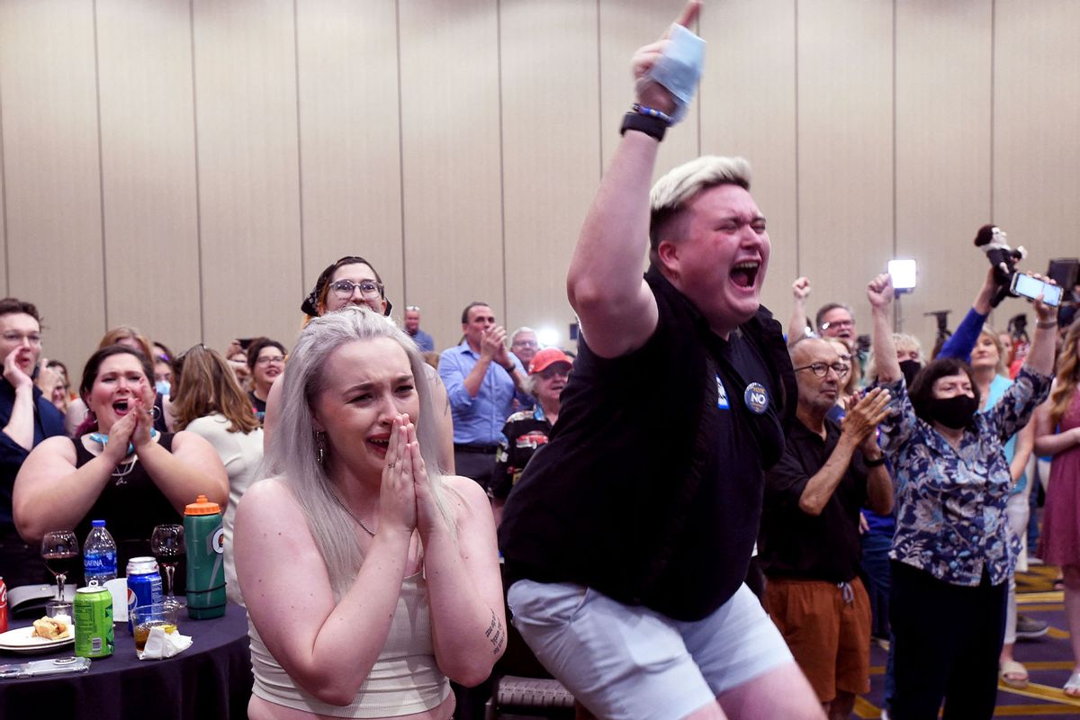 Abortion supporters Alie Utley and Joe Moyer (R) react to the failed constitutional amendment proposal at the Kansas Constitutional Freedom Primary Election Watch Party in Overland Park, Kansas on August 2, 2022. (DAVE KAUP/AFP via Getty Images)