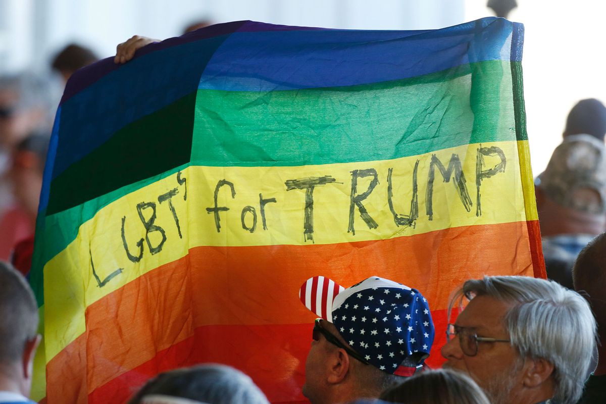 Supporters hold up a gay pride flag for Republican presidential candidate Donald Trump on October 18, 2016 (George Frey/Getty Images)