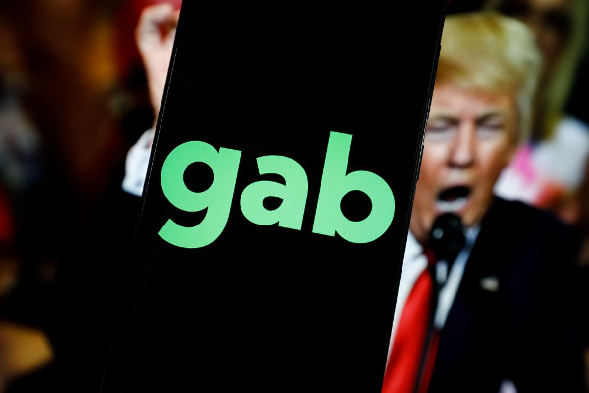 The Gab alt-tech social media logo with an image of former US president Donald Trump (STR/NurPhoto via Getty Images)