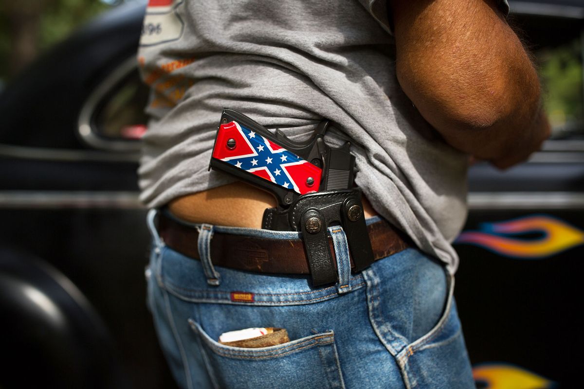 A man carries a handgun emblazoned with the Confederate battle flag during an unveiling of a monument to unknown Confederate dead at Confederate Veterans Memorial Park, which is owned privately, in Brantley, Ala., Aug. 27, 2017. (Kevin D. Liles/For the Washington Post/Getty Images)