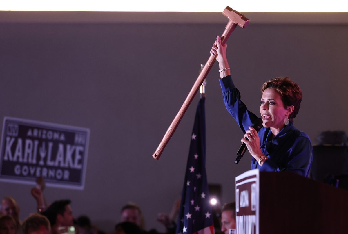 Republican candidate for Arizona Governor Kari Lake holds up a sledgehammer as she speaks to supporters that are waiting around as ballots continue to be counted during her primary election night gathering at the Double Tree Hotel on August 03, 2022 in Scottsdale, Arizona. (Justin Sullivan/Getty Images)