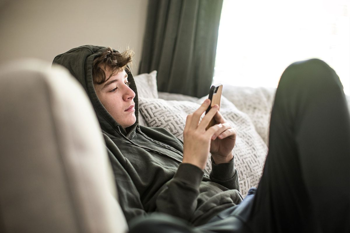 Teenage boy using smartphone (Getty Images/MoMo Productions)