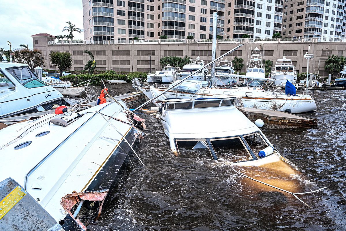 Boat are partially submerged at a marina in the aftermath of Hurricane Ian in Fort Myers, Florida, on September 29, 2022. (GIORGIO VIERA/AFP via Getty Images)