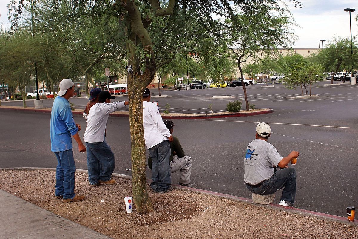 Immigrants from Mexico and Central America await day labor work on a curbside near a Home Depot in Phoenix, Arizona. (John Moore/Getty Images)