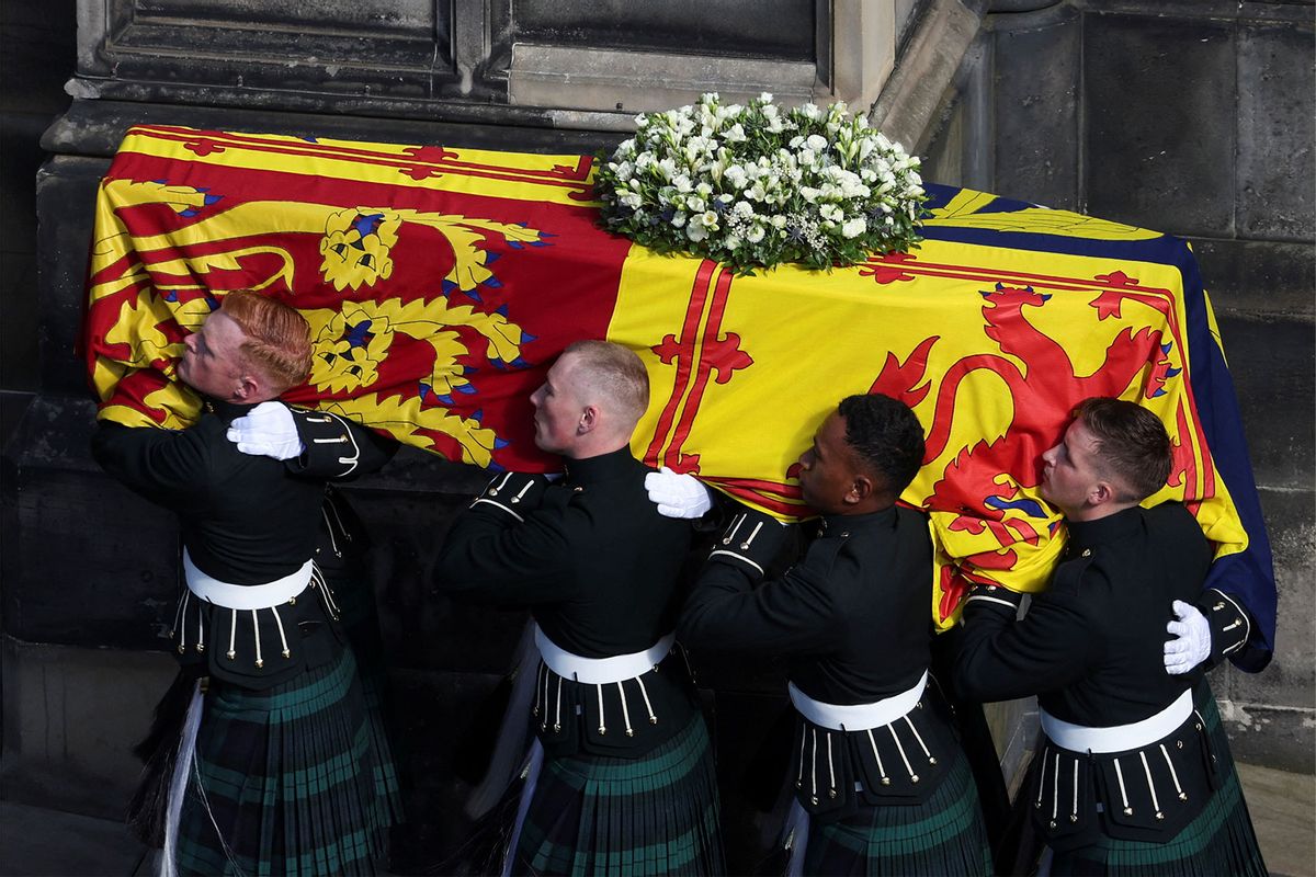 Pallbearers carry the coffin of Britain's Queen Elizabeth II as the hearse arrives at St. Giles' Cathedral after the procession from the Palace of Holyroodhouse on September 12, 2022 in Edinburgh, Scotland. (Russell Cheyne - WPA Pool/Getty Images)