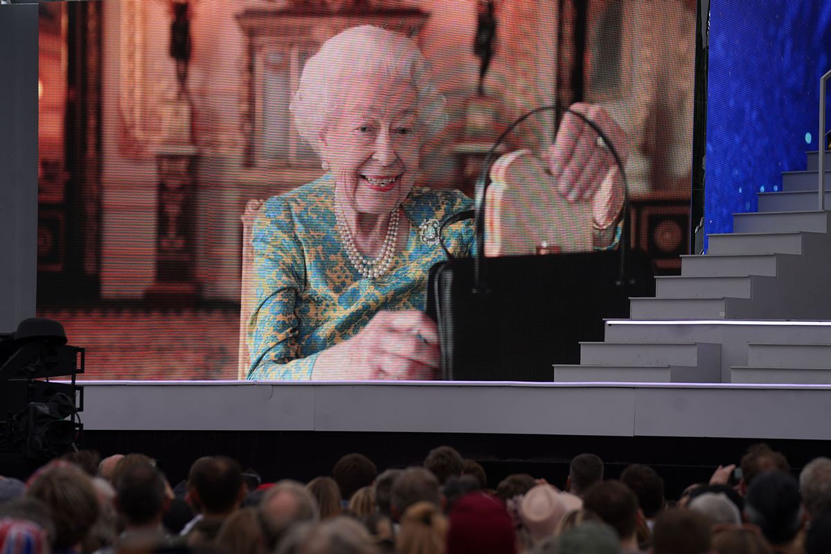 The crowd watching a film of Queen Elizabeth II having tea with Paddington Bear on a big screen during the Platinum Party at the Palace staged in front of Buckingham Palace, London on Saturday June 4, 2022. (Victoria Jones/PA Images via Getty Images)