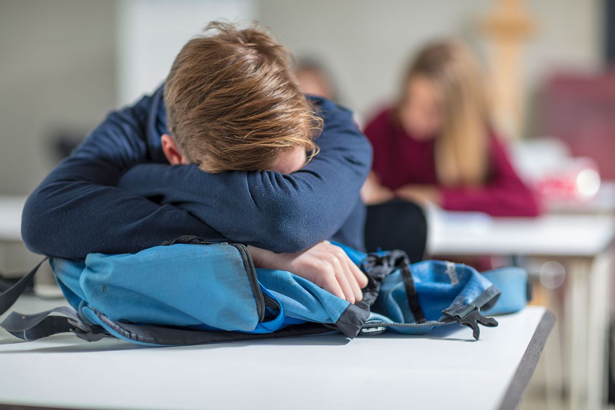 Teenage boy sleeping in class (Getty Images/Westend61)