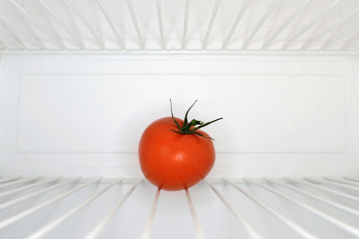 Single red tomato sitting on shelf inside refrigerator (Getty Images/PhotoAlto/Neville Mountford-Hoare)