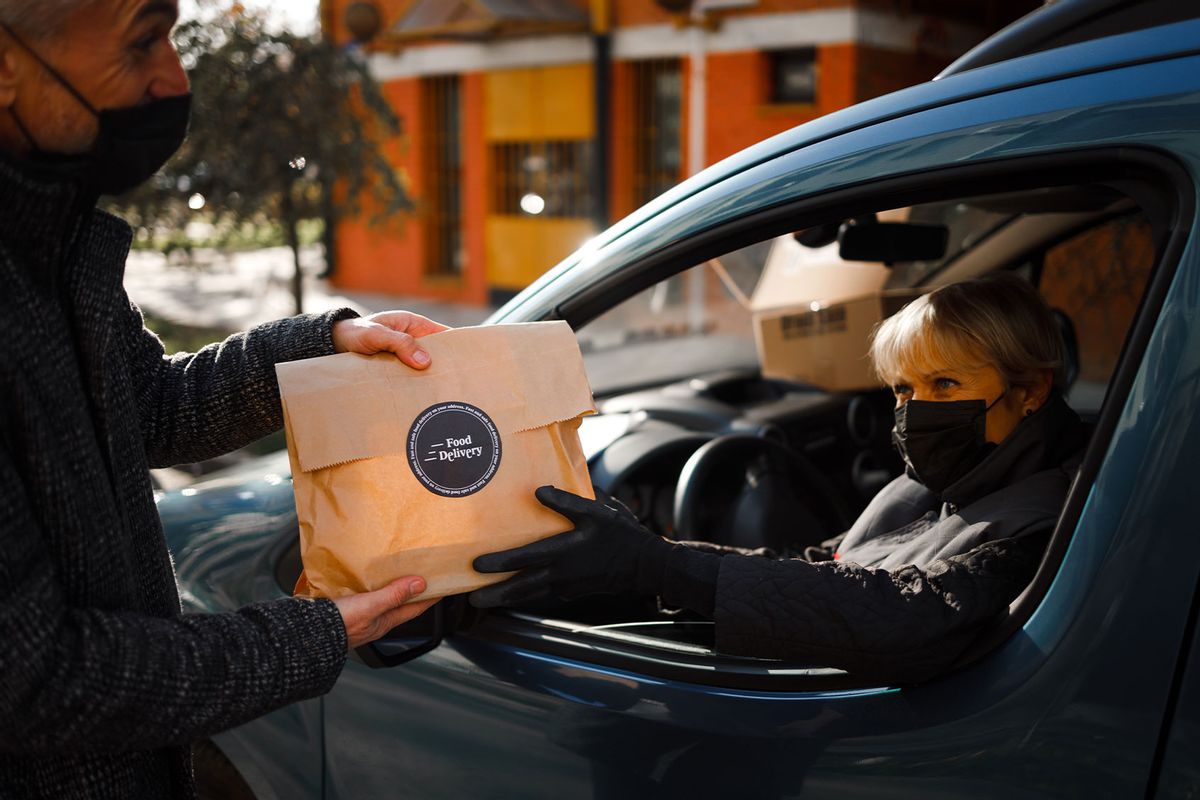 Male courier with orders in car. Food delivery service Stock Photo