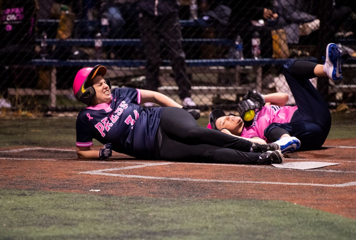 Abby Livingston, left, of The Texas Tribune, and Rep. Angie Craig, D-Minn., collide at home plate during the Congressional Women's Softball game that pits Congresswomen against female journalists at Watkins Recreation Center on Capitol Hill on Wednesday, October 27, 2021. (Tom Williams/CQ-Roll Call, Inc via Getty Images)
