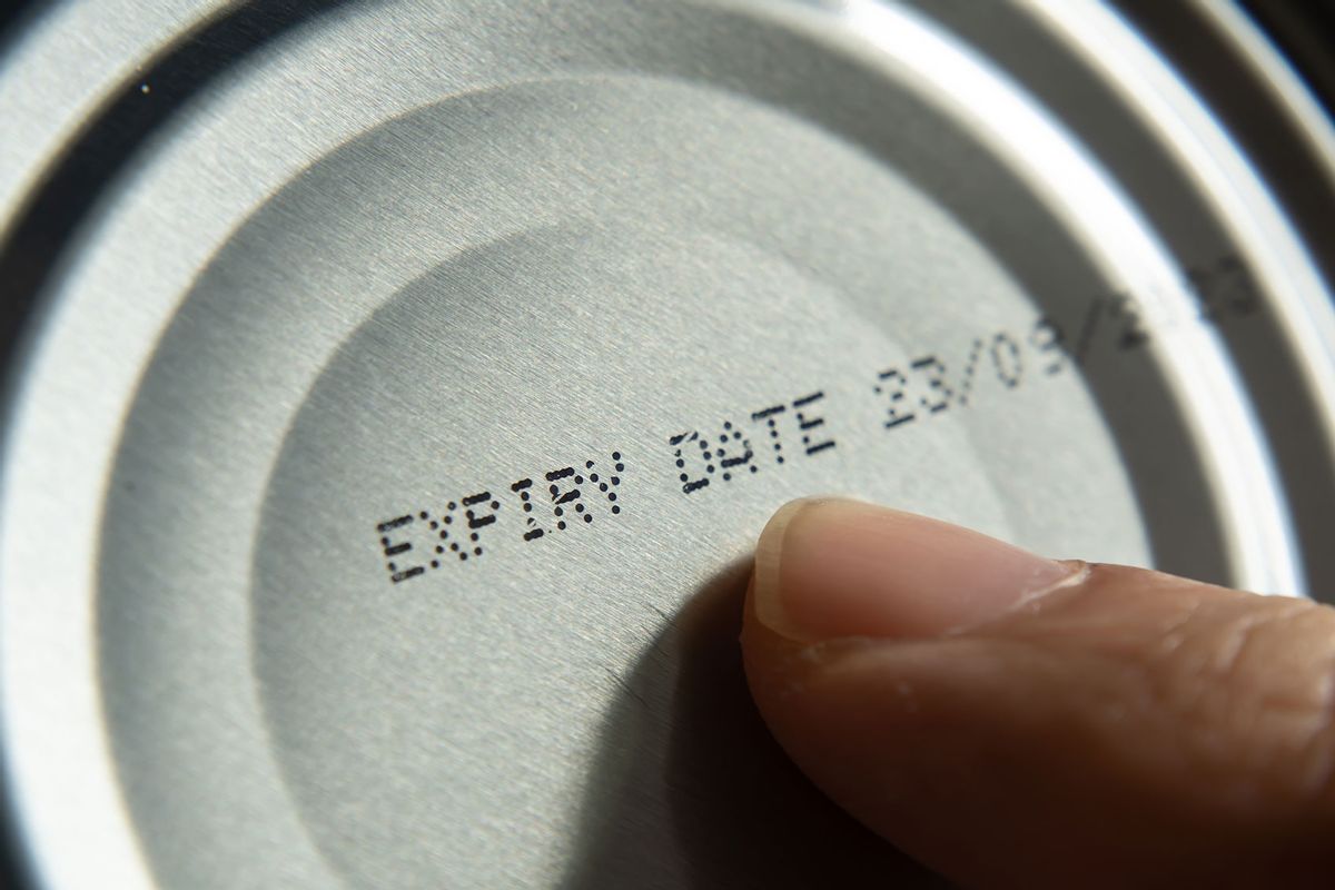 Finger pointing at the expiry date on canned food (Getty Images/Wachiwit)