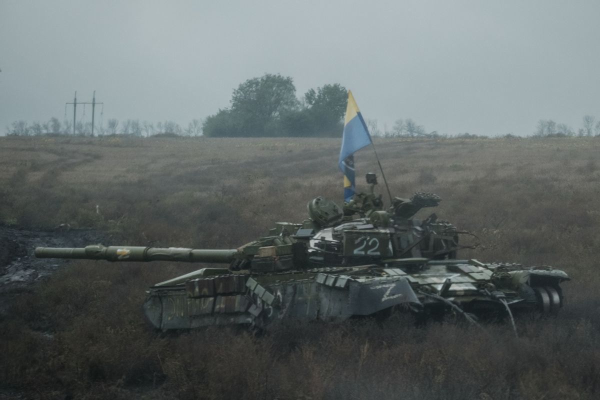 A Ukrainian flag flies on an abandoned Russian tank near Dolina in the Donetsk region of Ukraine, on Oct. 10, 2022.  (YASUYOSHI CHIBA/AFP via Getty Images)