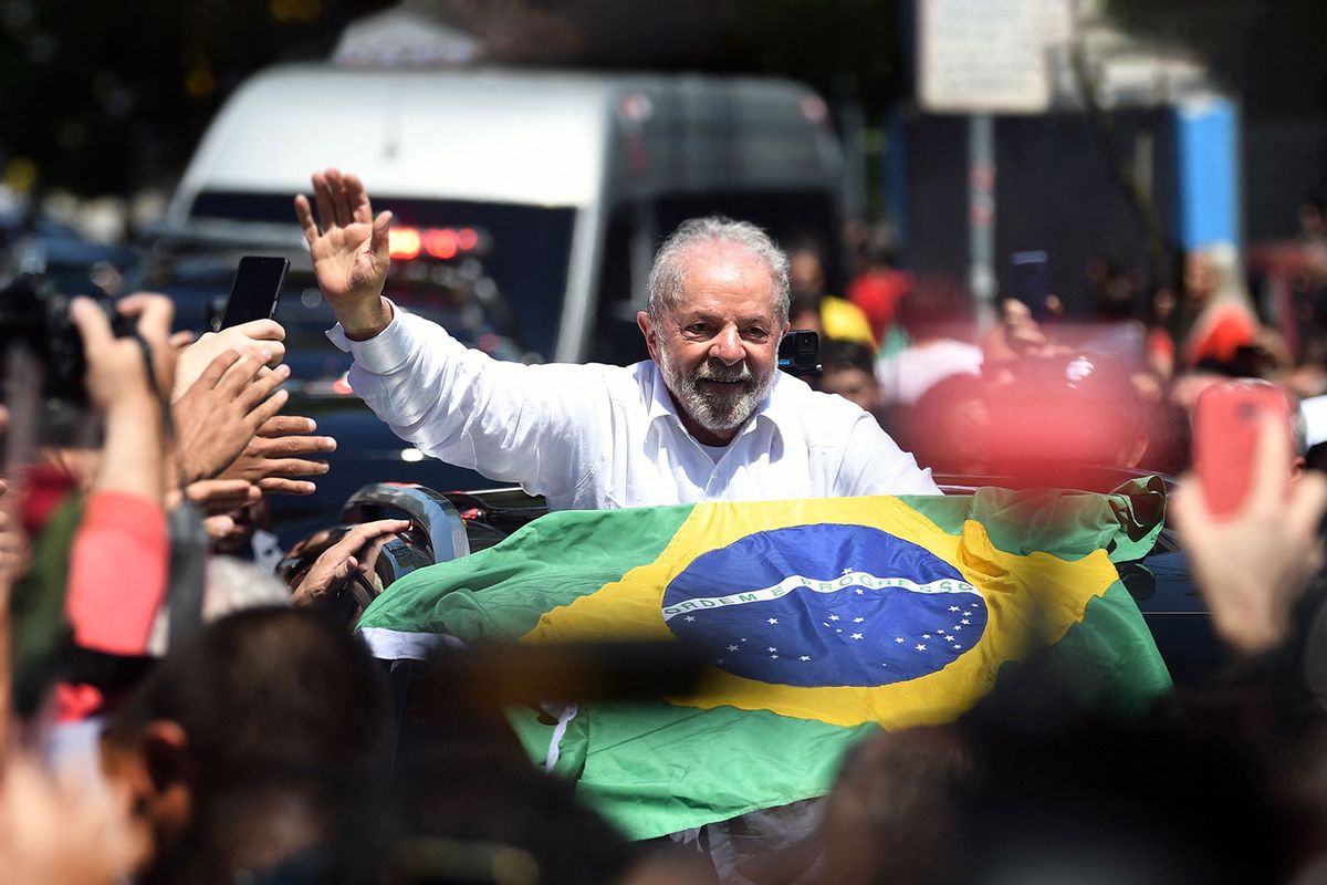 Brazilian former President (2003-2010) and candidate for the leftist Workers Party (PT) Luiz Inacio Lula da Silva waves at supporters while leaving the polling station, during the presidential run-off election, in Sao Paulo, Brazil, on October 30, 2022. (CARL DE SOUZA/AFP via Getty Images)