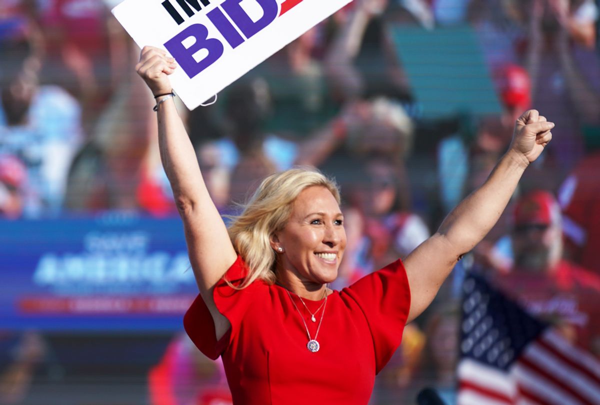 Rep. Marjorie Taylor Greene (R-GA) holds a sign that reads Impeach Biden at a rally featuring former US President Donald Trump on September 25, 2021 in Perry, Georgia. (Sean Rayford/Getty Images)