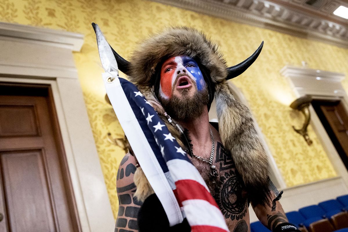 Jacob Chansley, also known as the "QAnon Shaman," screams "Freedom" inside the U.S. Senate chamber after the U.S. Capitol was breached by a mob during a joint session of Congress on January 6, 2021 in Washington, DC. (Win McNamee/Getty Images)