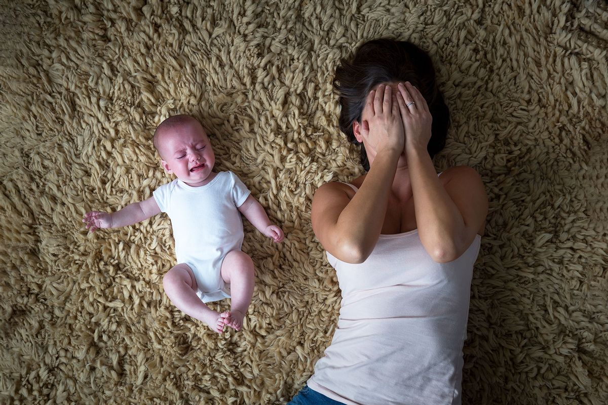 Stressed mother and her baby (Getty Images/SolStock)