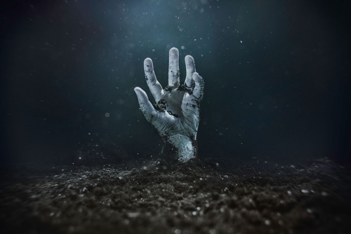 Zombie hand emerging from the ground (Getty Images/Marc Mateos)