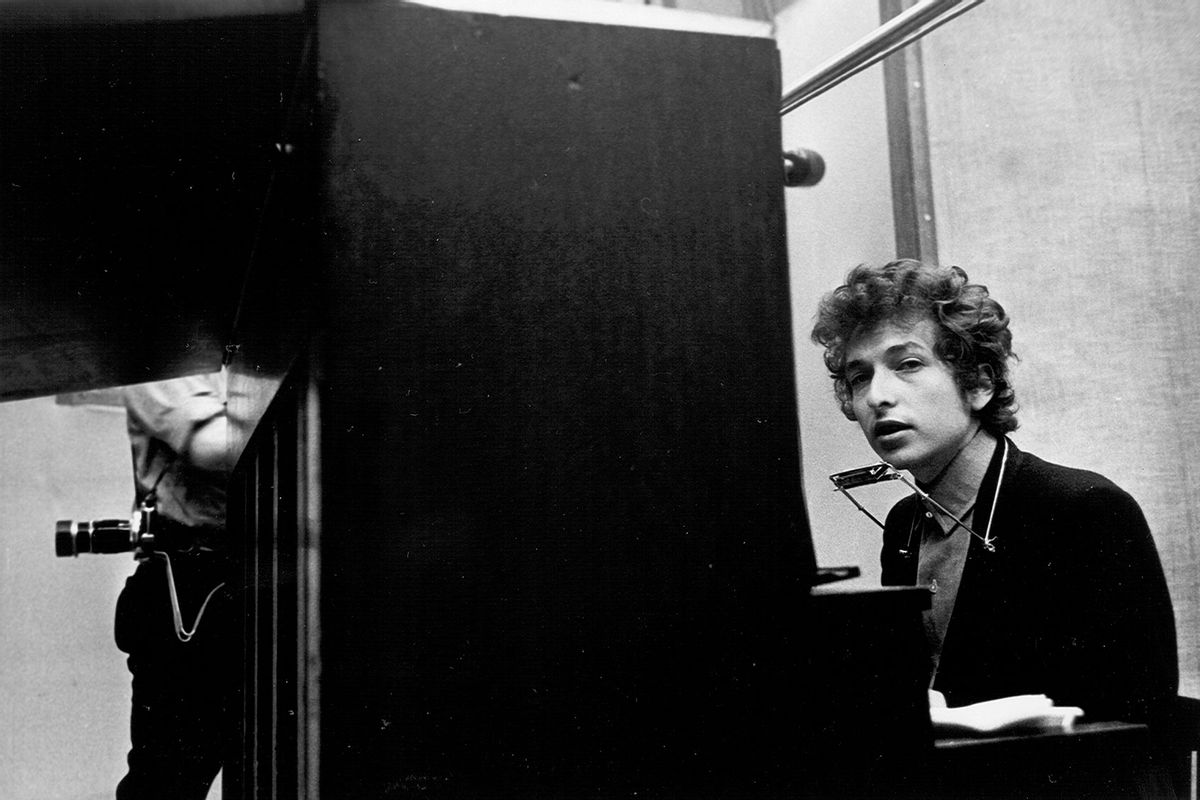 Bob Dylan (seated at the piano with a harmonica around his neck) takes a break during the recording of the album 'Highway 61 Revisited' in Columbia's Studio A in the summer of 1965 in New York City, New York. (Michael Ochs Archives/Getty Images)