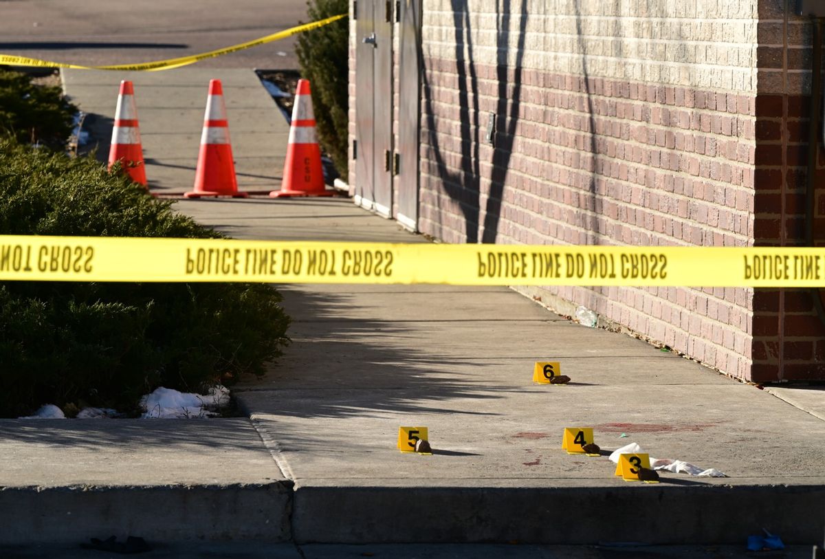 Evidence markers are placed at the scene near a 7-11 where a victim was found near Club Q on November 20, 2022 in Colorado Springs, Colorado.  (Helen H. Richardson/MediaNews Group/The Denver Post via Getty Images)