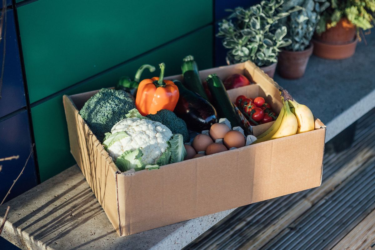 A delivery box filled with fresh organic vegetables and fruits on the front yard (Getty Images/Oscar Wong)
