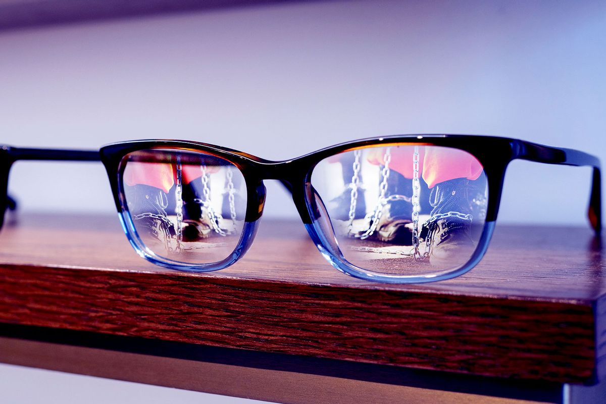 Prisoners reflected in glasses on a shelf (Photo illustration by Salon/Getty Images)