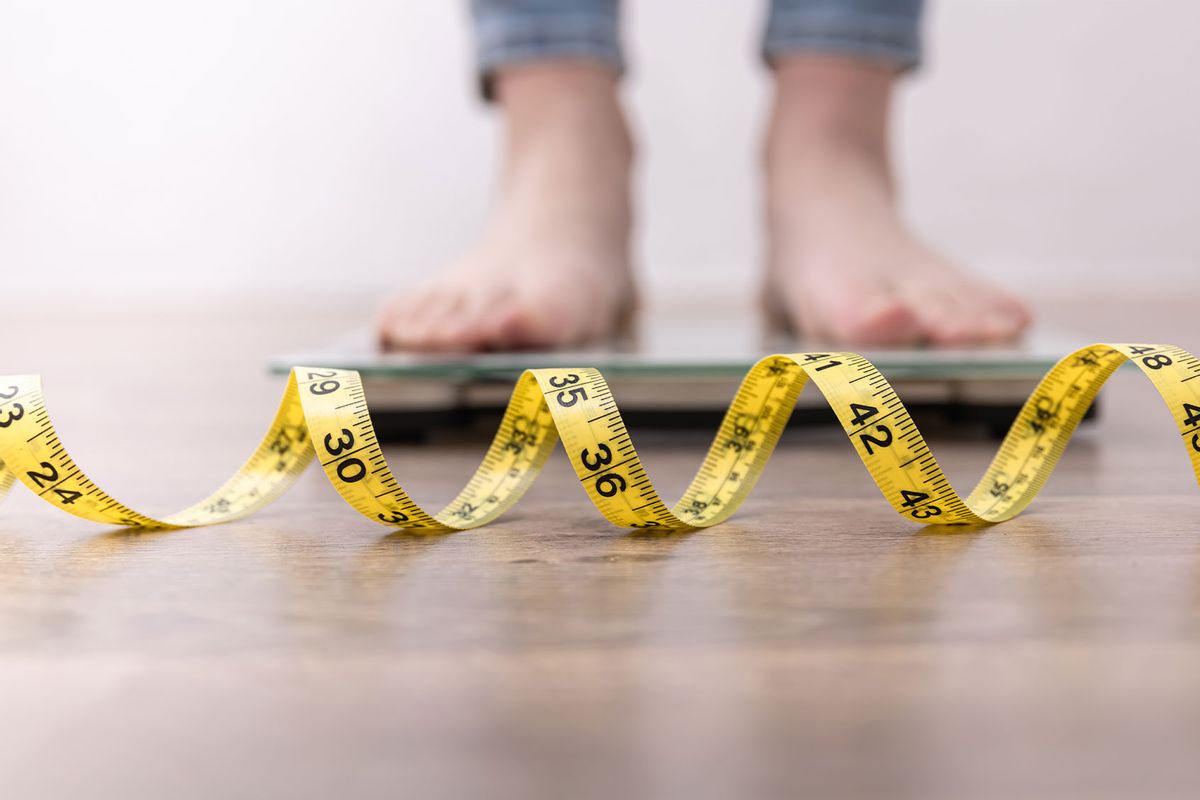 Weight scale with a measuring tape concept of diet