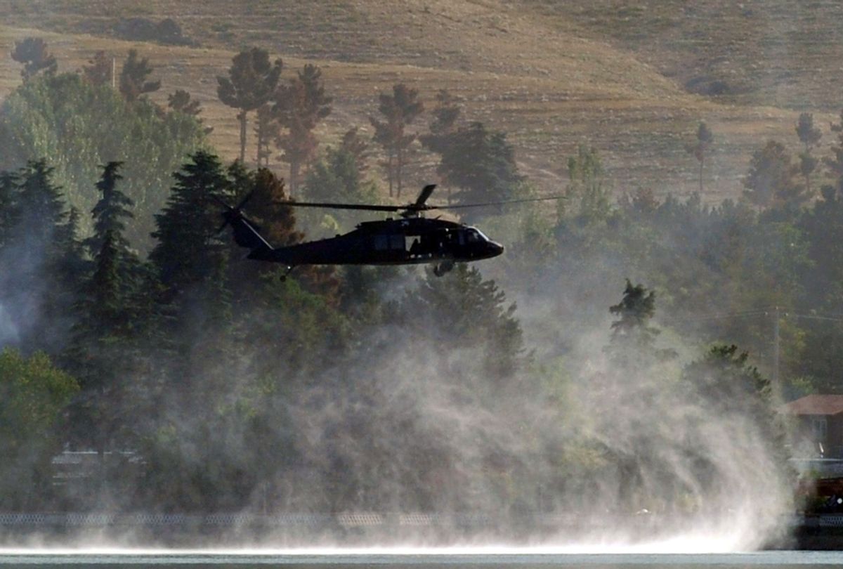 A military helicopter flies near the outskirts of Kabul on June 22, 2012. (MASSOUD HOSSAINI/AFP via Getty Images)