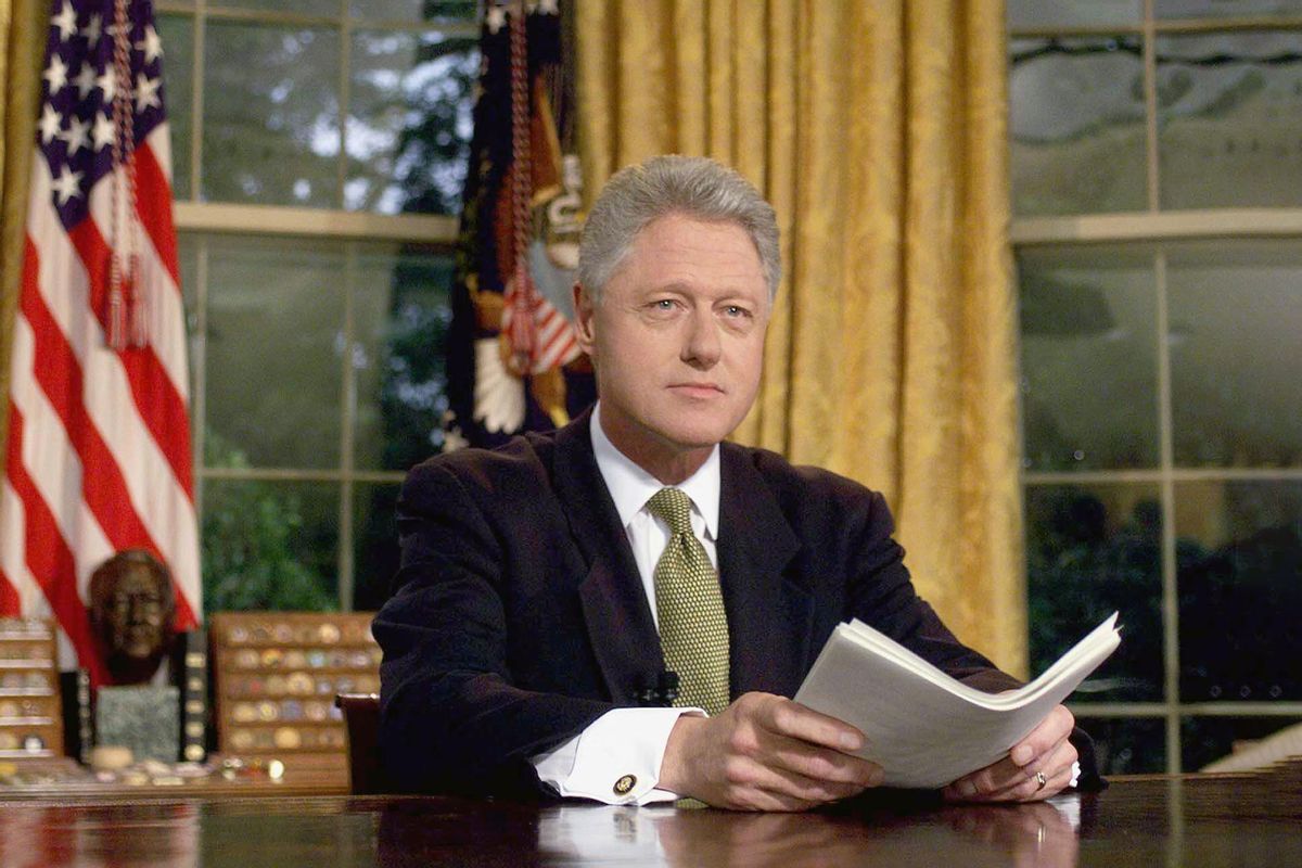 US President Bill Clinton poses for photographs after addressing the nation from the Oval Office in the White House 10 June, 1999. (JOYCE NALTCHAYAN/AFP via Getty Images)