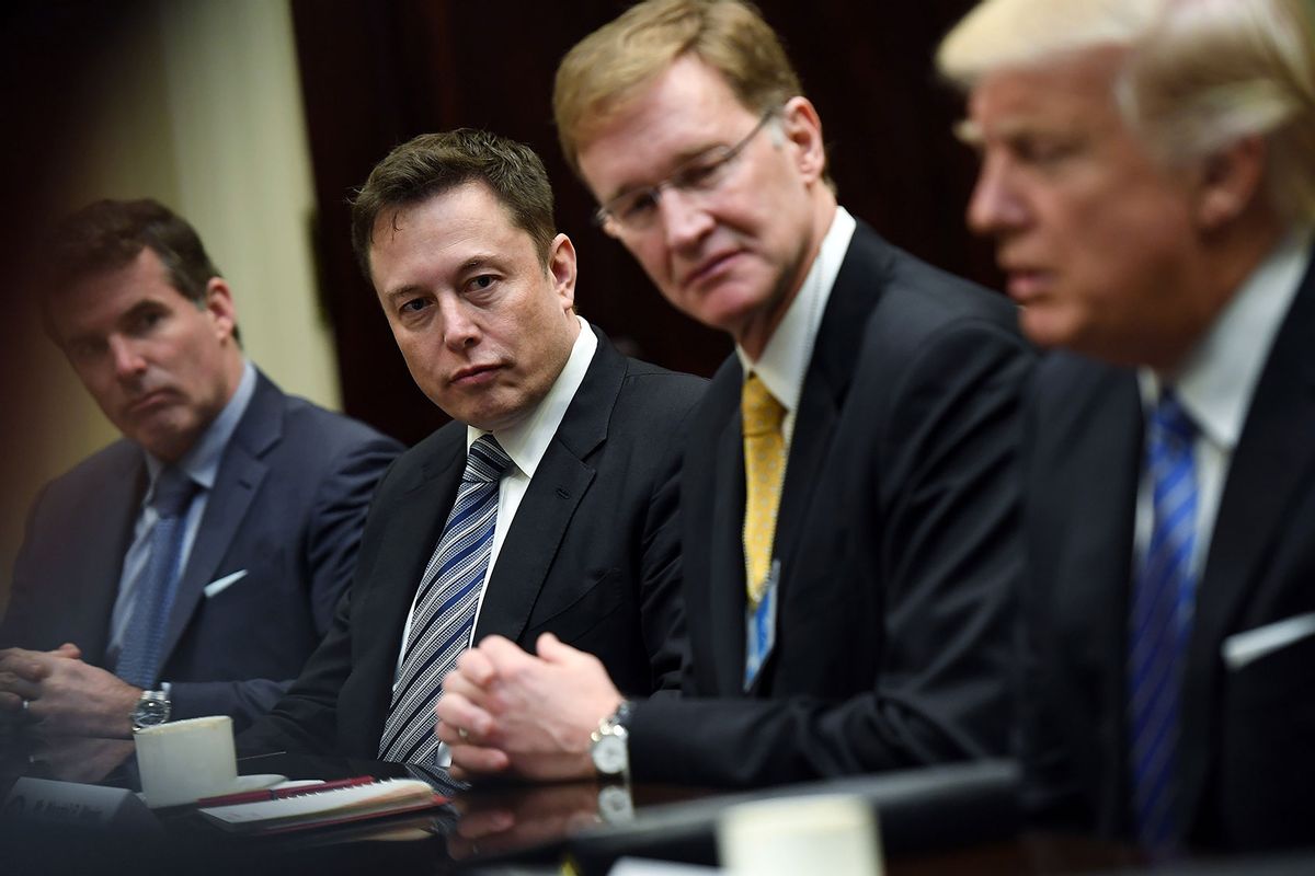 Elon Musk, left center, and Wendell P. Weeks, right center, listen to President Donald Trump, right, as he meets with business leaders at the White House on Monday January 23, 2017 in Washington, DC. (Matt McClain/The Washington Post via Getty Images)