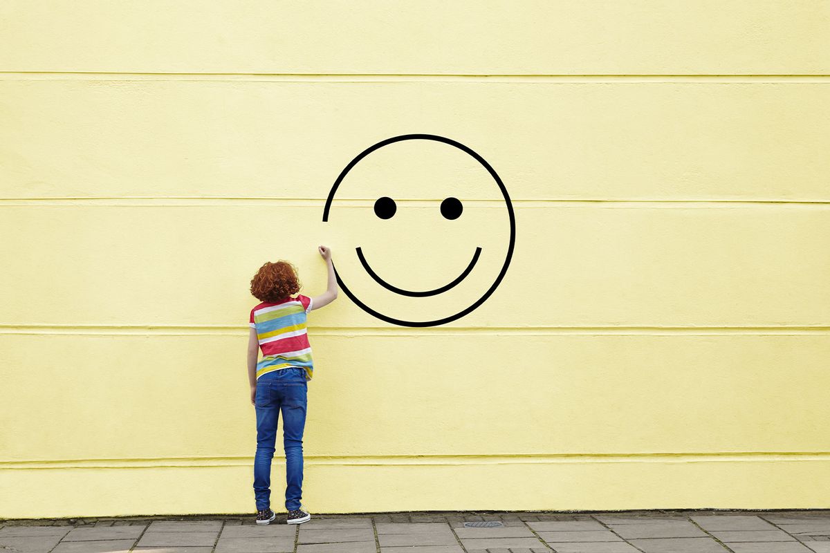 Girl drawing smiley face on to a wall (Getty Images/Flashpop)