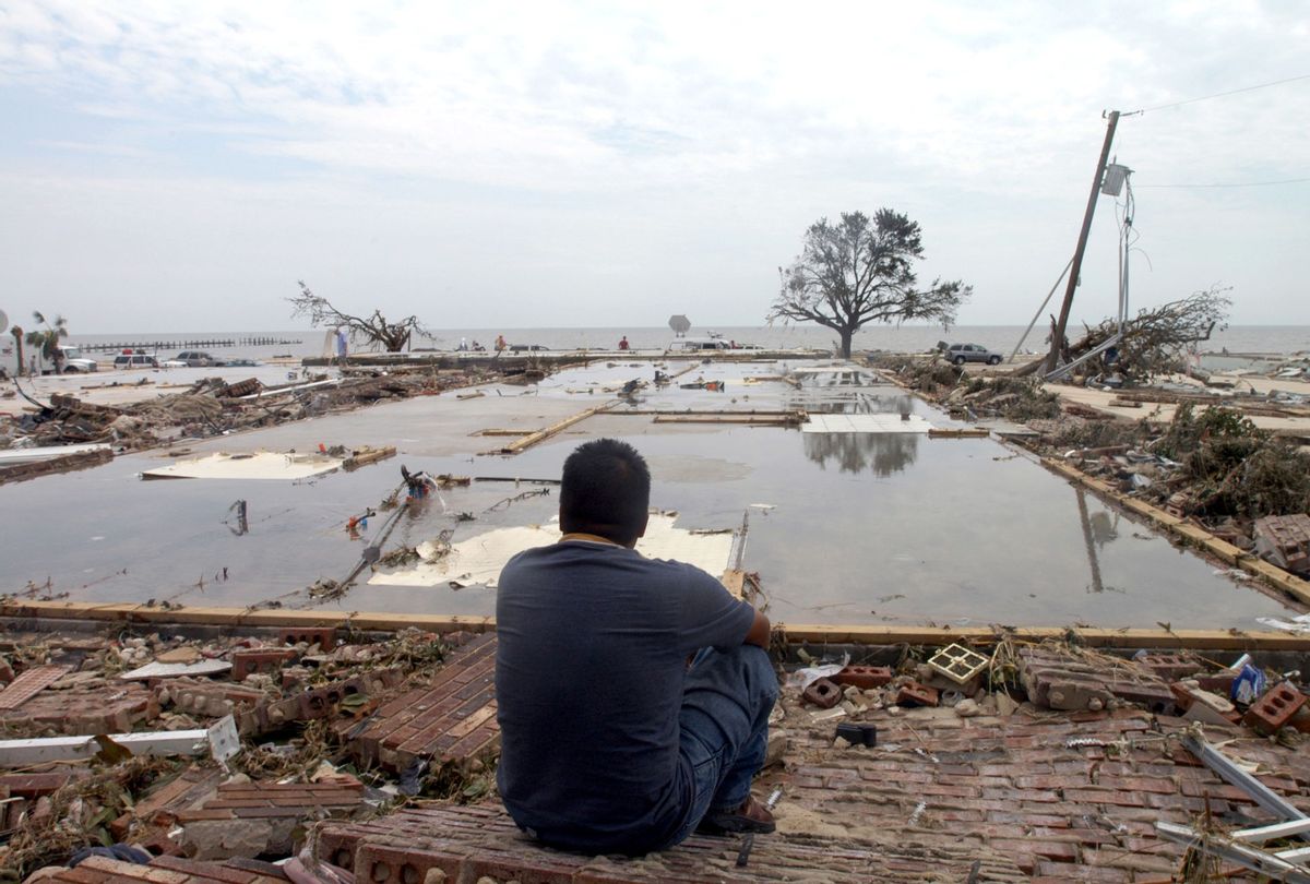 A man looks over the concrete slab that used to be his apartment after Hurricane Katrina, August 30, 2005. (Barry Williams/Getty Images)