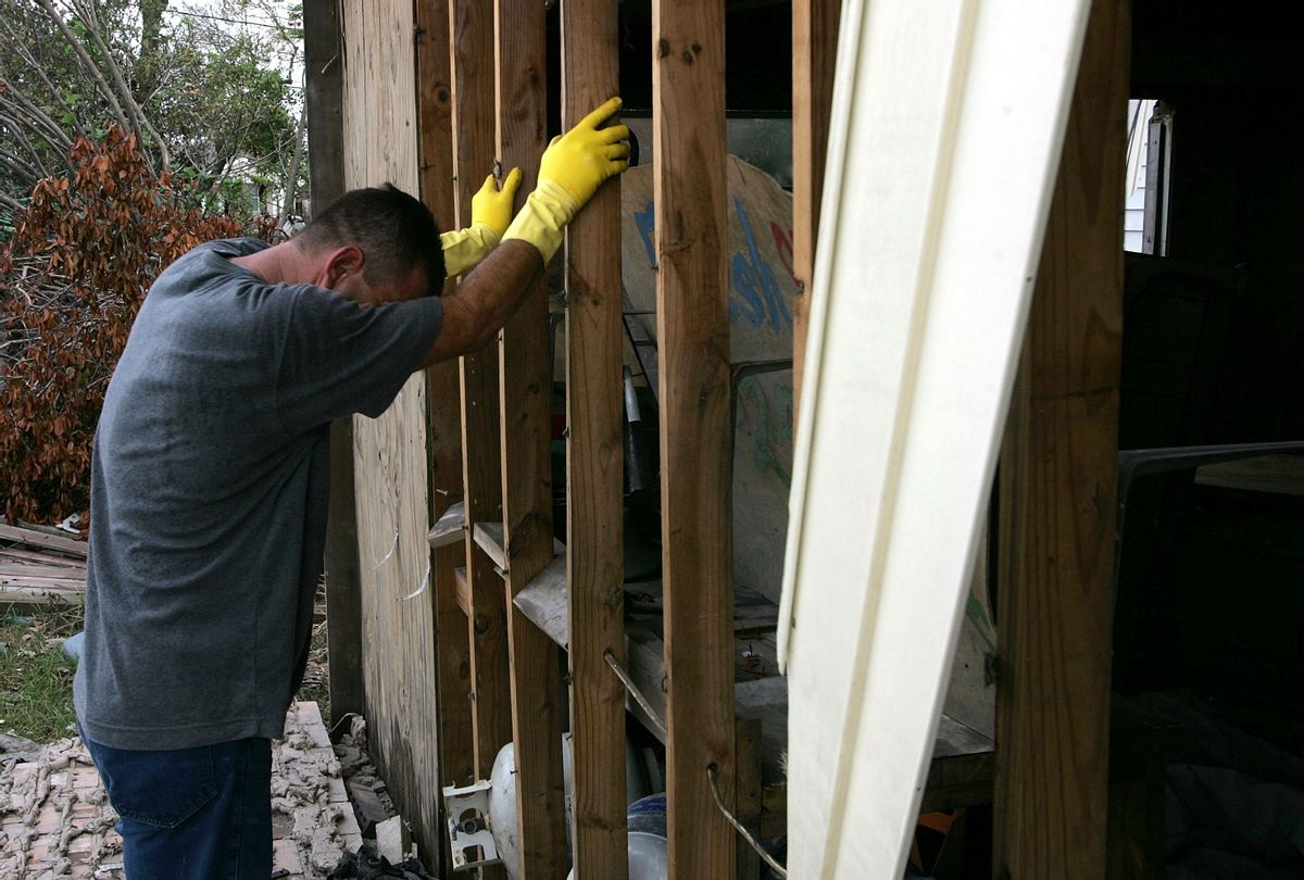 A St. Bernard Parish resident cries as he removes debris from his home September 17, 2005 in Chalmette, Louisiana.  (Justin Sullivan/Getty Images)