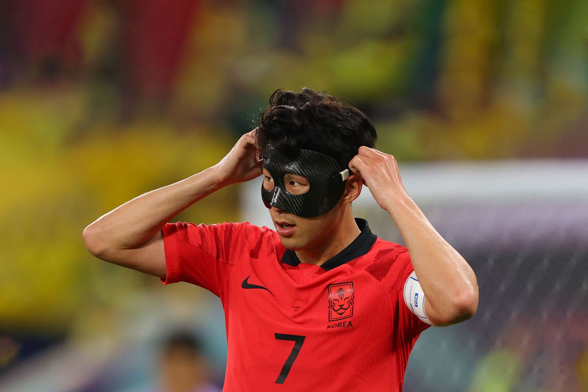 Son Heung-min of Korea Republic adjusts his protective face mask during the FIFA World Cup Qatar 2022 Round of 16 match between Brazil and South Korea at Stadium 974 on December 5, 2022 in Doha, Qatar. (Marc Atkins/Getty Images)