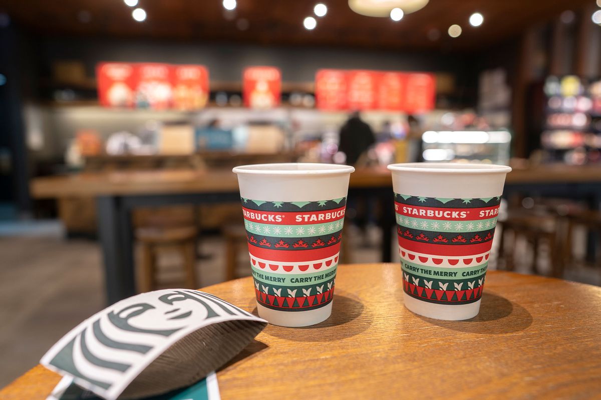 Paper coffee cups specially made for Christmas on the table in a Starbucks store. (Zhang Peng/LightRocket via Getty Images)