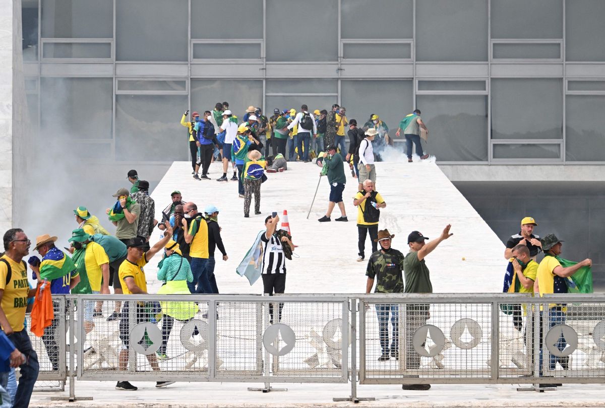 Supporters of Brazilian former President Jair Bolsonaro clash with the police during a demonstration outside Brazil's National Congress headquarters in Brasilia on January 8, 2023. (EVARISTO SA/AFP via Getty Images)