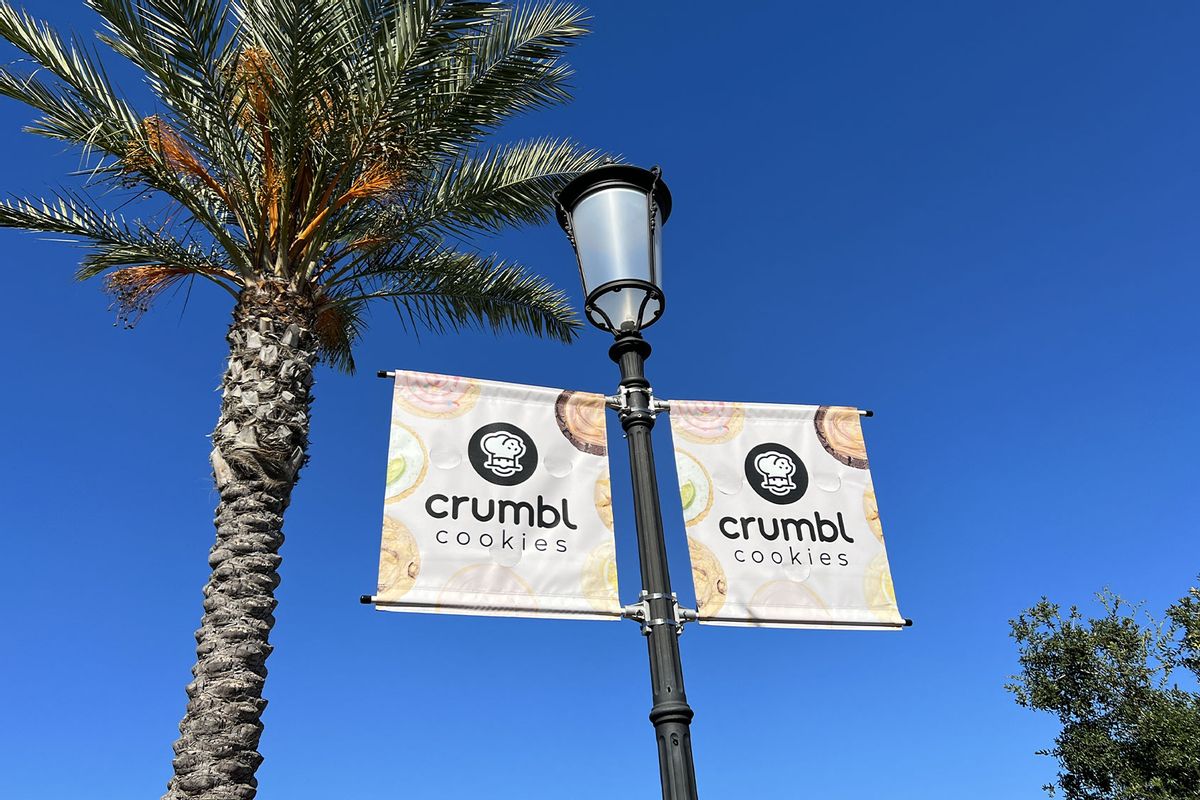 Signs for Crumbl Cookies beside a palm tree at Veranda shopping center in Concord, California (Gado/Getty Images)
